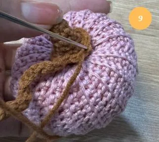 Sewing the stem and vine to the pumpkin